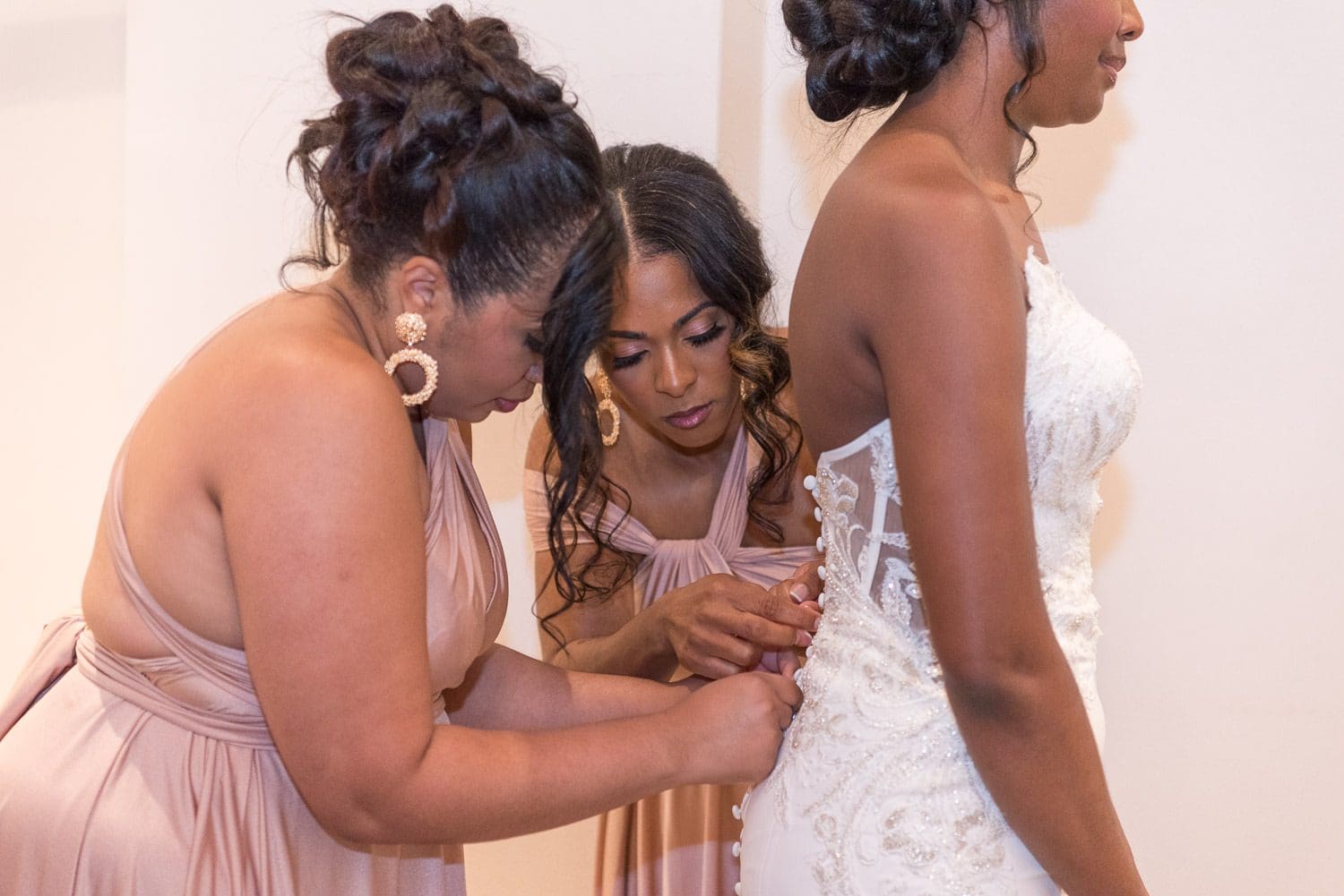 Atlanta Wedding Photographer FAQ - bride being dressed